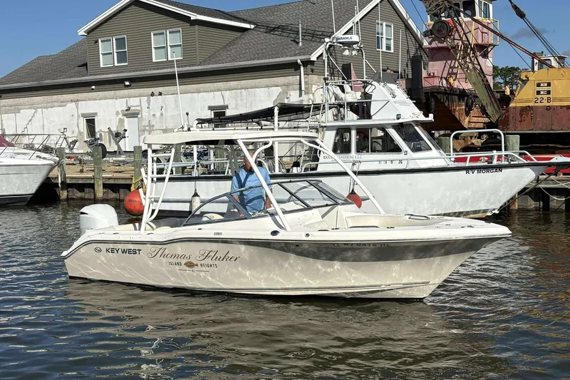 Slide: The Image of 2020 Key West 239 DFS boat docked near industrial buildings. - 16