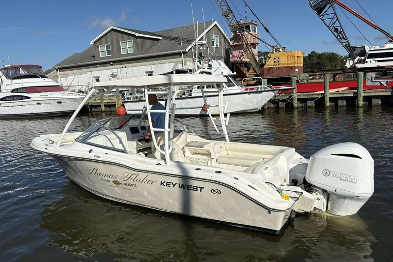 Slide: The Image of 2020 Key West 239 DFS boat docked, featuring Yamaha engine, marina background. - 2