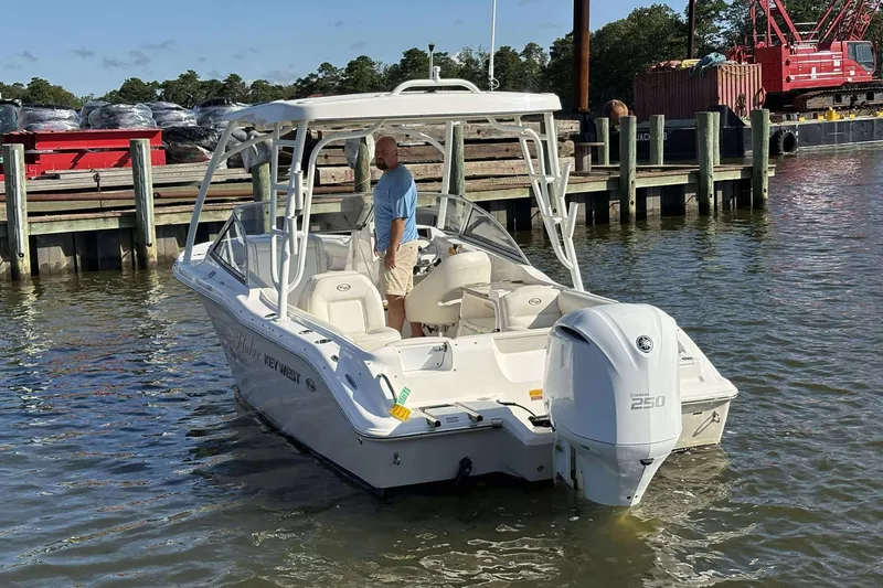 Slide: The Image of 2020 Key West 239 DFS boat docked, featuring Yamaha 250 engine, with a person onboard. - 3