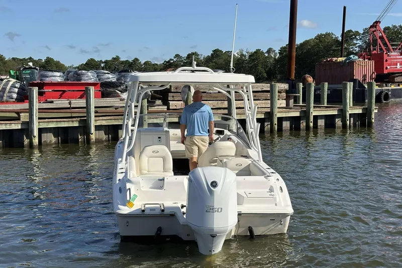 Slide: The Image of 2020 Key West 239 DFS boat docked at a marina with a person onboard. - 5