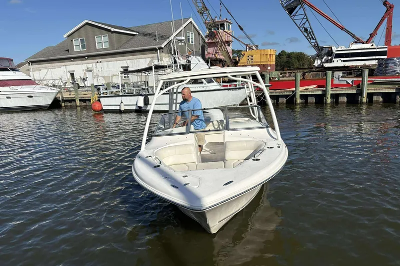Slide: The Image of 2020 Key West 239 DFS boat docked near marina with cranes and buildings. - 6