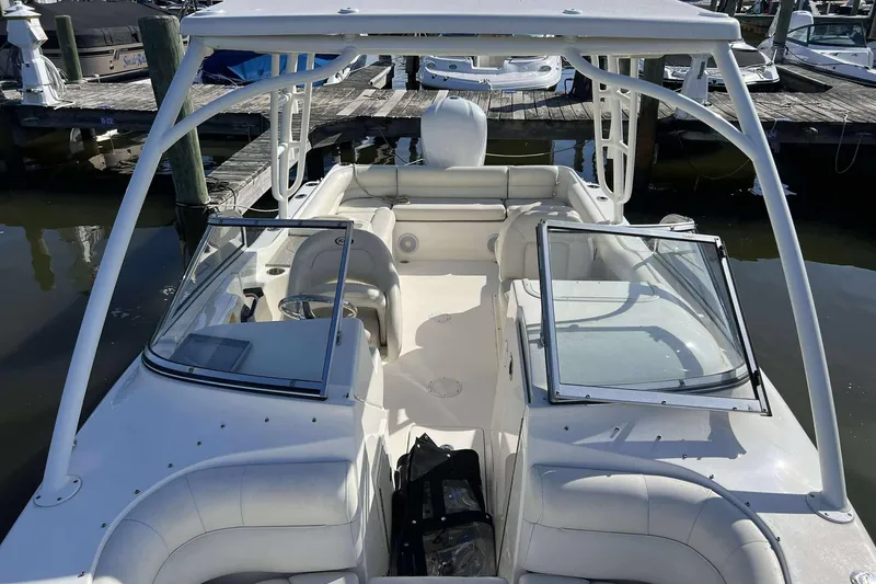 Slide: The Image of 2020 Key West 239 DFS boat interior at marina, featuring seating and open deck. - 7