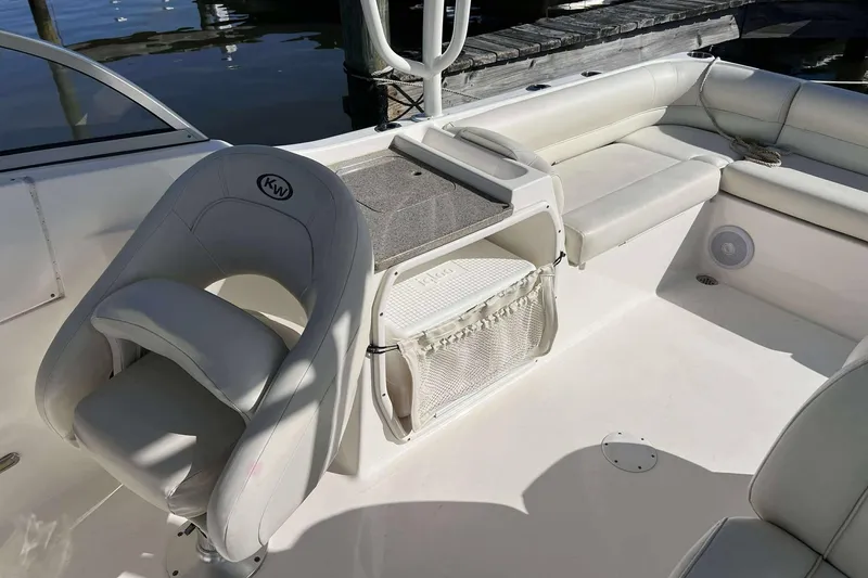 Slide: The Image of 2020 Key West 239 DFS boat interior with seating and storage, docked by the water. - 9