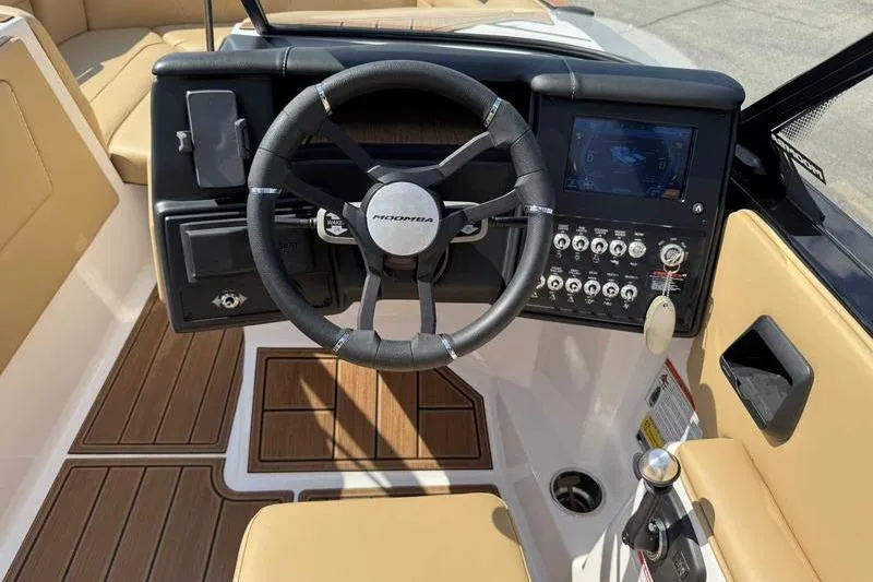 Slide: The Image of 2023 Moomba Max boat dashboard with steering wheel and control panel. - 13
