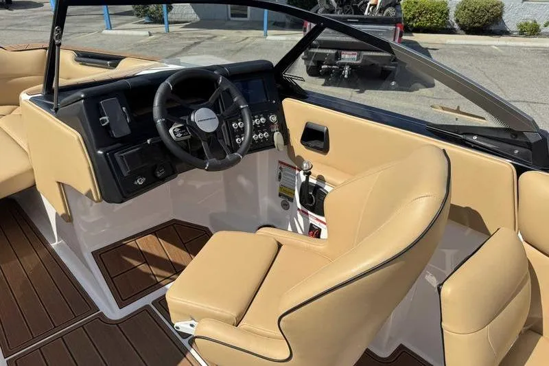 Slide: The Image of 2023 Moomba Max boat interior with tan seats and modern dashboard. - 15