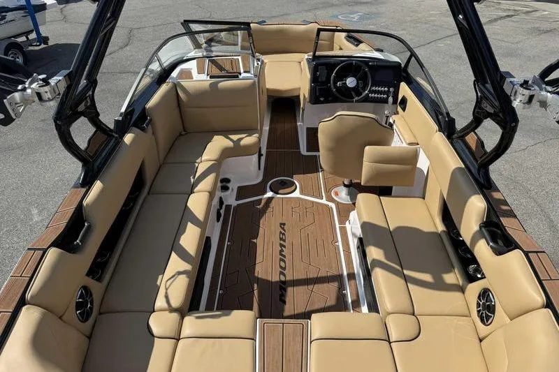 Slide: The Image of 2023 Moomba Max boat interior with tan seating and modern dashboard. - 4