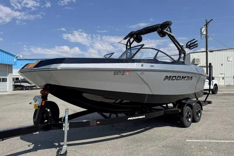 Slide: The Image of 2023 Moomba Max boat on trailer in parking lot under clear sky. - 6