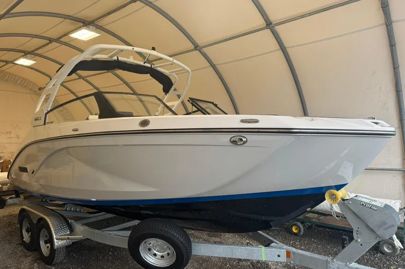 The Image of 2026 Yamaha Boats 222SD on trailer in covered storage area. - 0