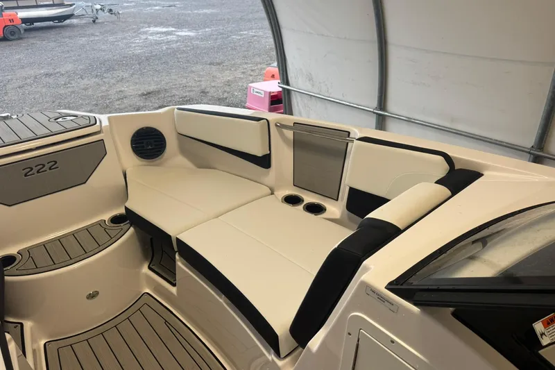 Slide: The Image of 2026 Yamaha Boats 222SD interior view, showcasing sleek seating and modern design in a covered area. - 11