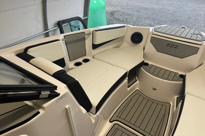Slide: The Image of 2026 Yamaha Boats 222SD in a covered storage, on a trailer, side view. - 3