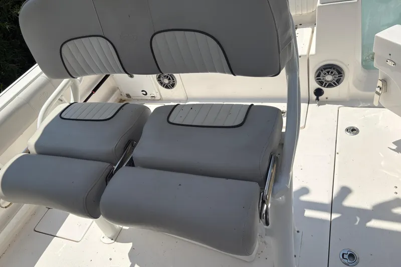 Slide: The Image of 2021 Sea Fox 268 Commander boat seating with white cushioned seats and stainless steel accents. - 7