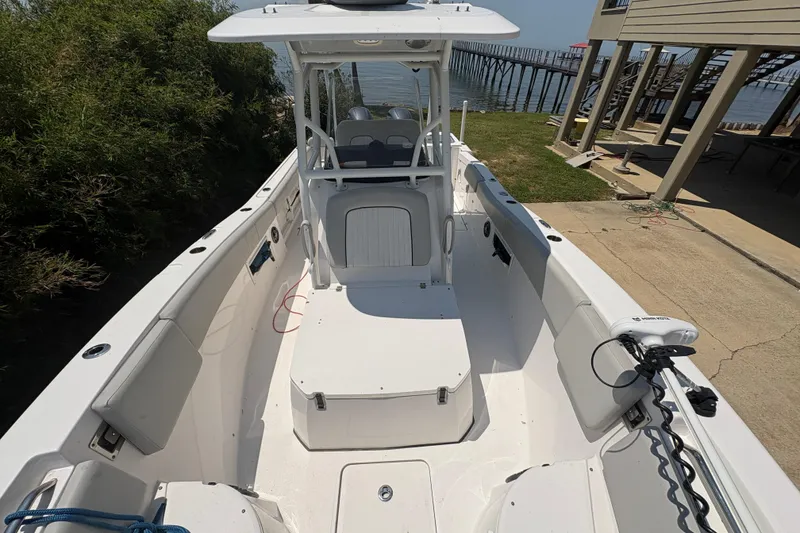 Slide: The Image of 2021 Sea Fox 268 Commander boat docked near a pier, showcasing spacious deck layout. - 8