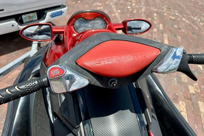 Slide: The Image of 2006 Sea-Doo RXT handlebars with start/stop button, red accents, and mirrors. - 10