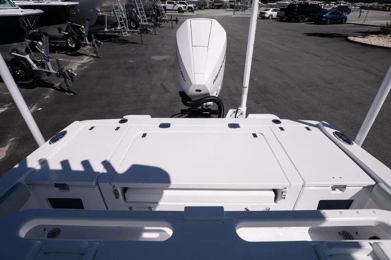 Slide: The Image of 2026 Blackfin 242 HB boat with powerful outboard motor in a marina setting. - 13