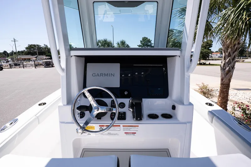 Slide: The Image of 2026 Blackfin 242 HB boat helm with Garmin navigation system and steering wheel. - 16