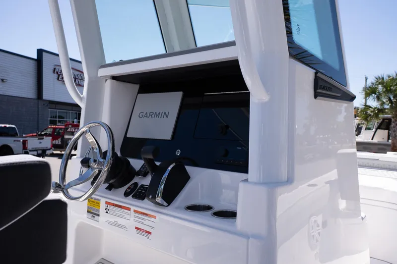 Slide: The Image of 2026 Blackfin 242 HB boat console with Garmin navigation system and steering wheel. - 17