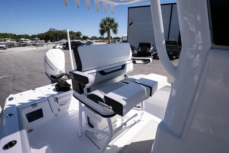 Slide: The Image of 2026 Blackfin 242 HB boat interior with seating and Mercury engine in a marina setting. - 20