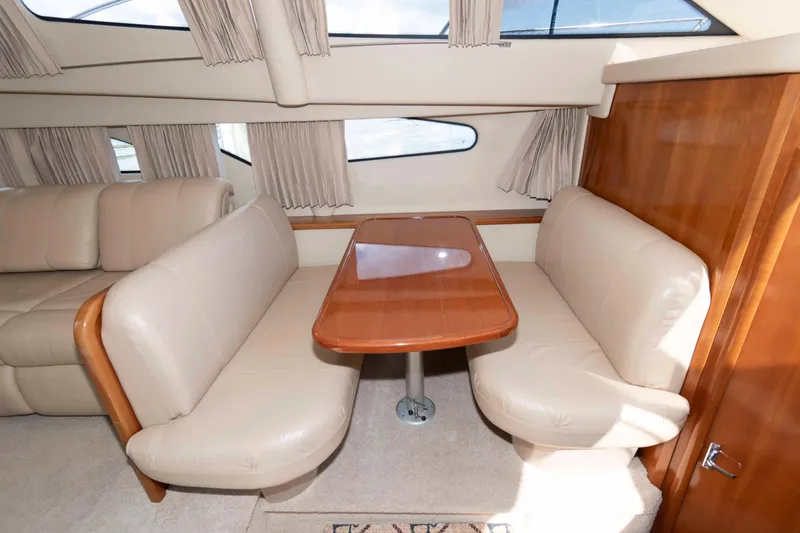 Slide: The Image of Luxurious interior of 2005 Carver 41 Cockpit Motor Yacht with elegant seating and table. - 19