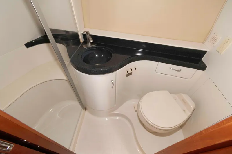 Slide: The Image of 2005 Carver 41 Cockpit Motor Yacht bathroom with sink, toilet, and shower. - 22