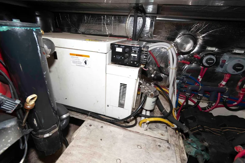 Slide: The Image of Engine room of 2005 Carver 41 Cockpit Motor Yacht with generator and wiring. - 28