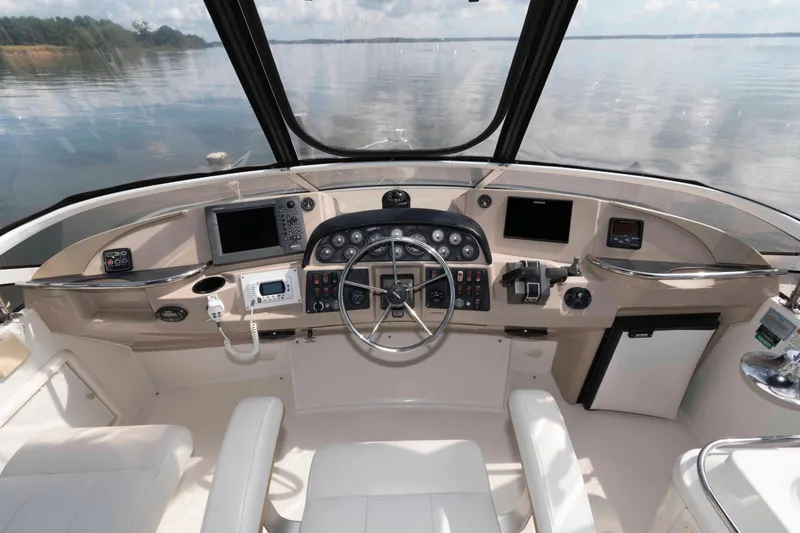 Slide: The Image of Cockpit of 2005 Carver 41 Cockpit Motor Yacht with steering wheel and navigation equipment. - 9