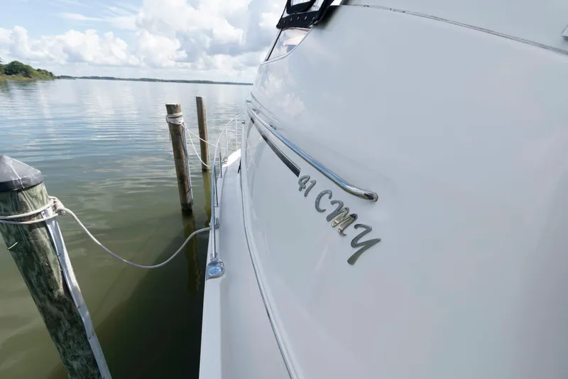 Slide: The Image of 2005 Carver 41 Cockpit Motor Yacht docked on calm water. - 12