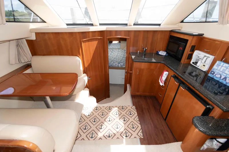 Slide: The Image of Interior of 2005 Carver 41 Cockpit Motor Yacht with kitchen and dining area. - 17