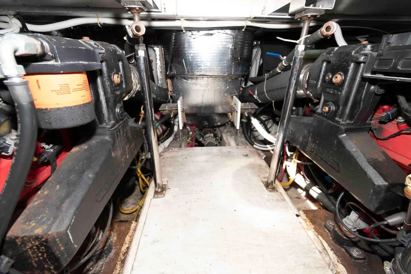 Slide: The Image of Engine room of a 2005 Carver 41 Cockpit Motor Yacht, showcasing mechanical components. - 25