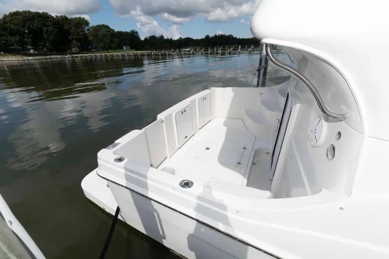 Slide: The Image of 2005 Carver 41 Cockpit Motor Yacht docked on calm water, showcasing spacious deck. - 3
