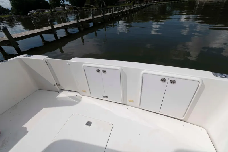 Slide: The Image of 2005 Carver 41 Cockpit Motor Yacht, spacious deck view by the water. - 4
