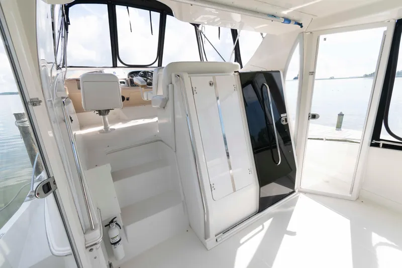 Slide: The Image of 2005 Carver 41 Cockpit Motor Yacht interior with helm and seating area. - 5