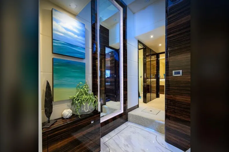 Slide: The Image of Luxurious yacht interior with modern decor, featuring abstract ocean paintings and elegant wood finishes. - 14