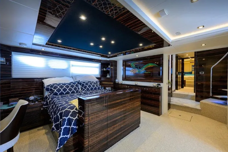Slide: The Image of Luxurious 2014 Hampton Fly yacht bedroom with elegant wood paneling and modern decor. - 16
