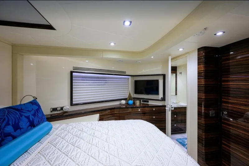 Slide: The Image of Luxurious 2014 Hampton Fly yacht bedroom with modern decor and elegant wood finishes. - 25