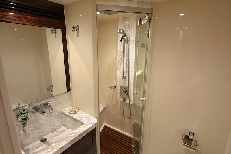 Slide: The Image of Luxurious bathroom in 2014 Hampton Fly yacht with marble sink and glass shower. - 30