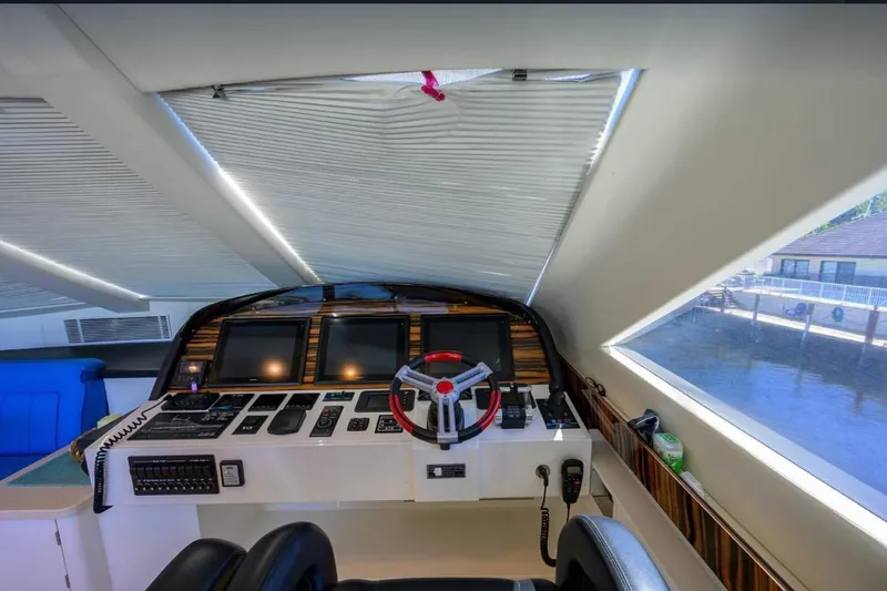 Slide: The Image of Cockpit of 2014 Hampton Fly yacht with modern navigation equipment and panoramic windows. - 35