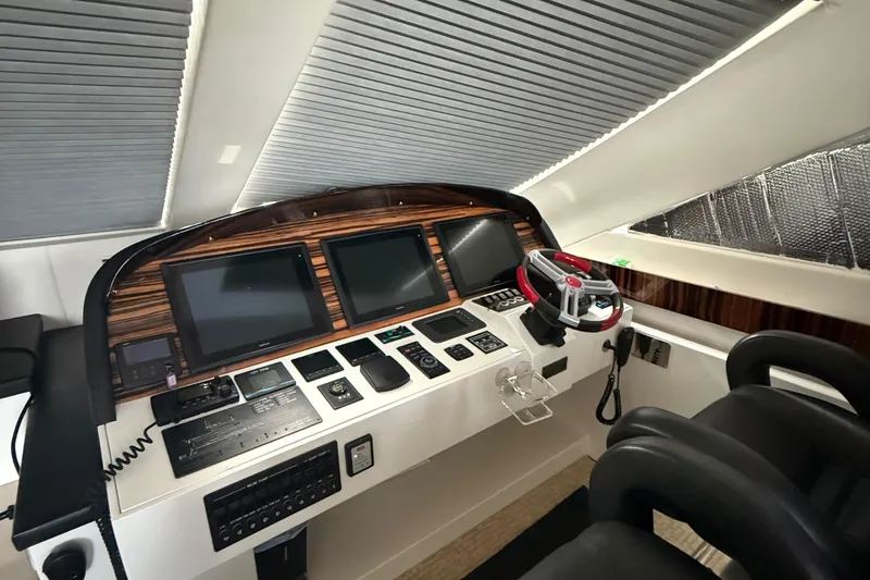 Slide: The Image of Control panel of a 2014 Hampton Fly yacht with modern navigation screens. - 36