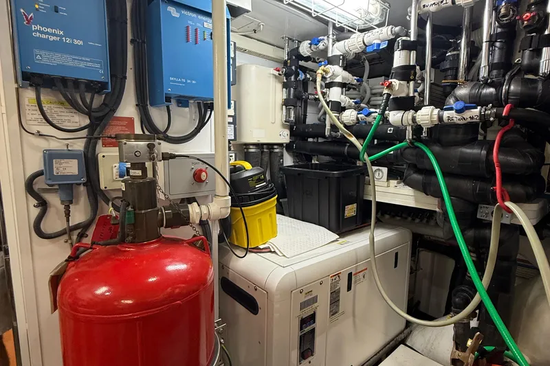 Slide: The Image of Engine room of a 2014 Hampton Fly, featuring complex machinery and wiring. - 43