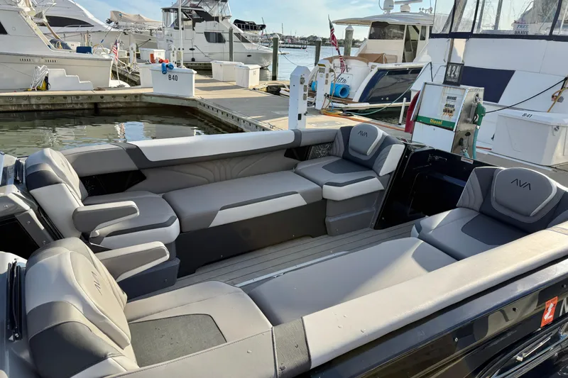 Slide: The Image of 2025 Avalon Excalibur Quad Lounge Windshield boat interior at marina dock. - 19