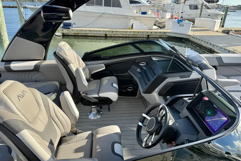 Slide: The Image of 2025 Avalon Excalibur Quad Lounge Windshield boat interior with modern dashboard and luxurious seating. - 2