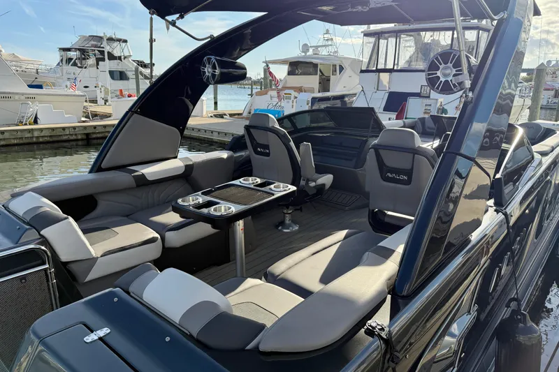 Slide: The Image of Luxurious 2025 Avalon Excalibur Quad Lounge Windshield boat docked at marina. - 21
