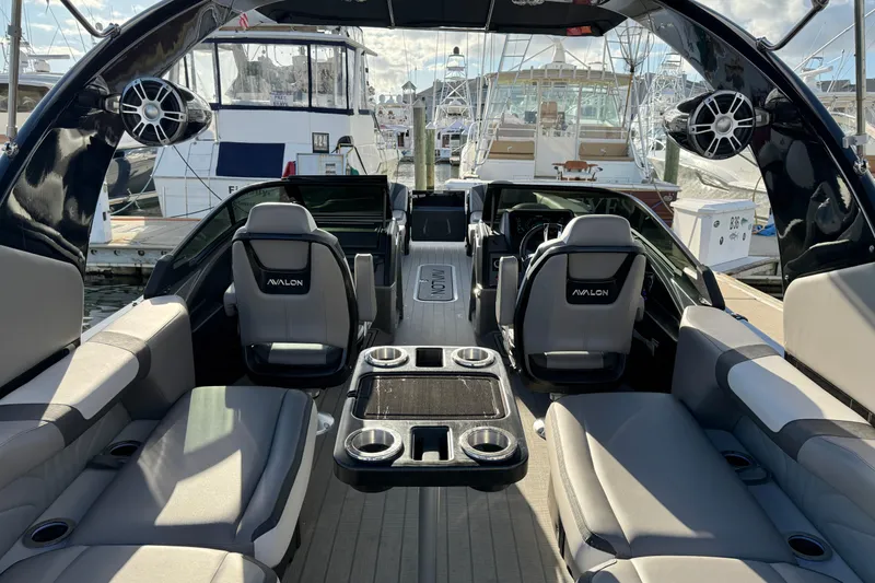 Slide: The Image of 2025 Avalon Excalibur Quad Lounge Windshield boat interior with luxurious seating and modern design. - 22