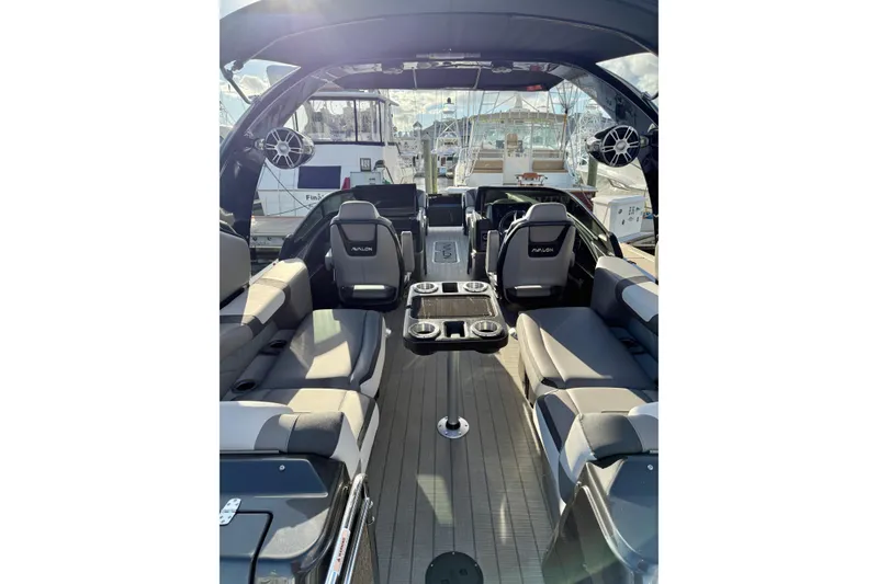 Slide: The Image of 2025 Avalon Excalibur Quad Lounge Windshield boat interior with luxurious seating and modern design. - 23
