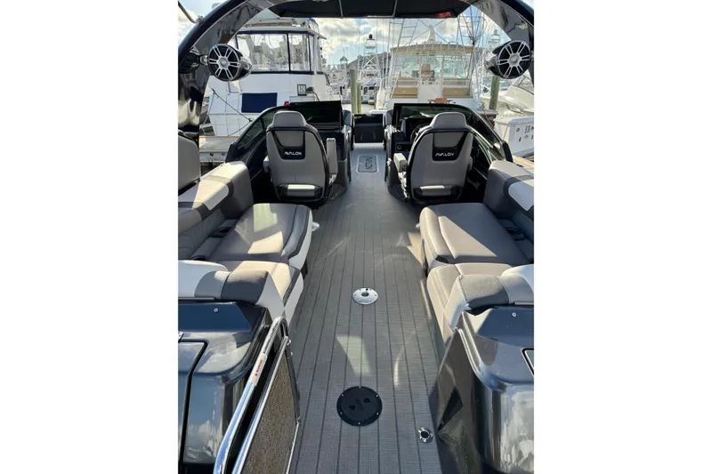 Slide: The Image of 2025 Avalon Excalibur Quad Lounge Windshield boat interior with luxurious seating and modern design. - 27