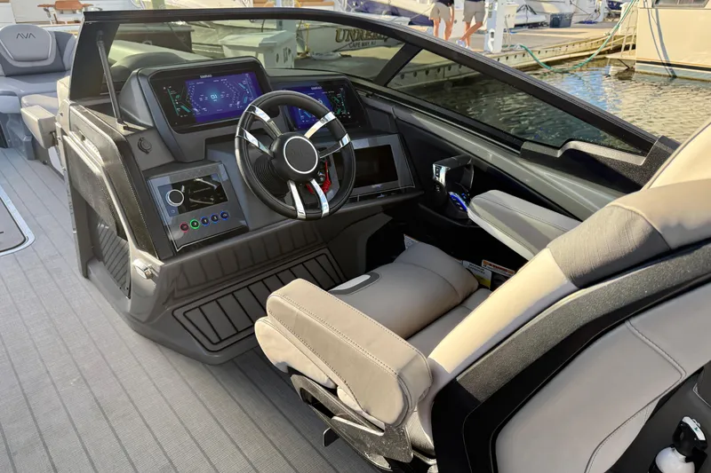 Slide: The Image of 2025 Avalon Excalibur Quad Lounge Windshield boat interior with modern dashboard and steering wheel. - 28