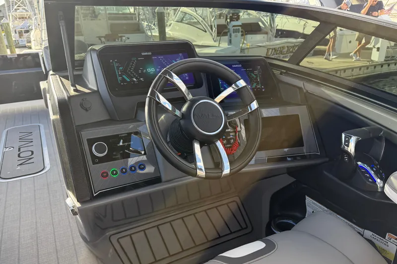 Slide: The Image of 2025 Avalon Excalibur Quad Lounge Windshield boat dashboard with modern controls and steering wheel. - 29