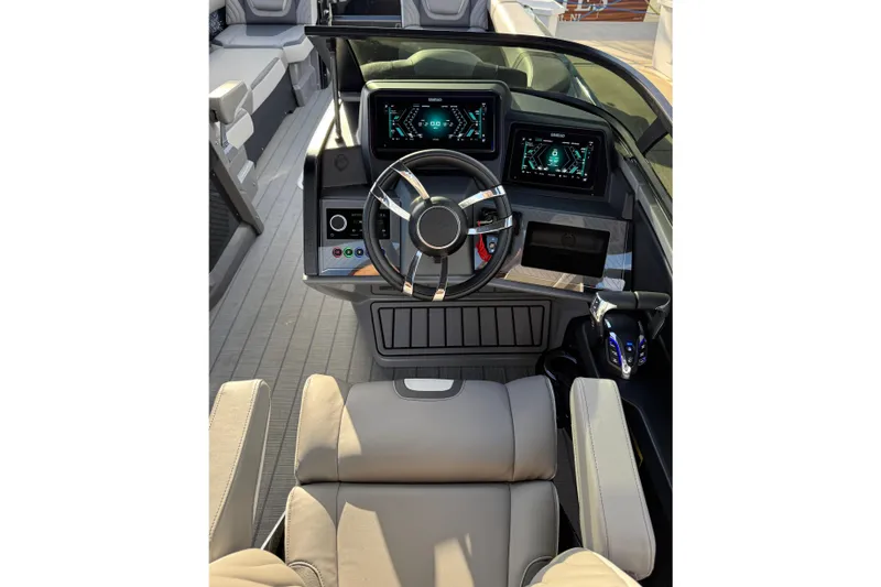Slide: The Image of 2025 Avalon Excalibur Quad Lounge Windshield boat interior with modern dashboard and steering wheel. - 30