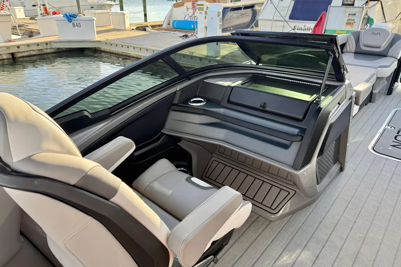 Slide: The Image of 2025 Avalon Excalibur Quad Lounge Windshield boat interior at marina dock. - 32