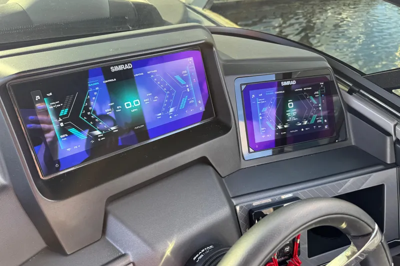 Slide: The Image of Dashboard of 2025 Avalon Excalibur with dual Simrad displays, showcasing advanced controls. - 34