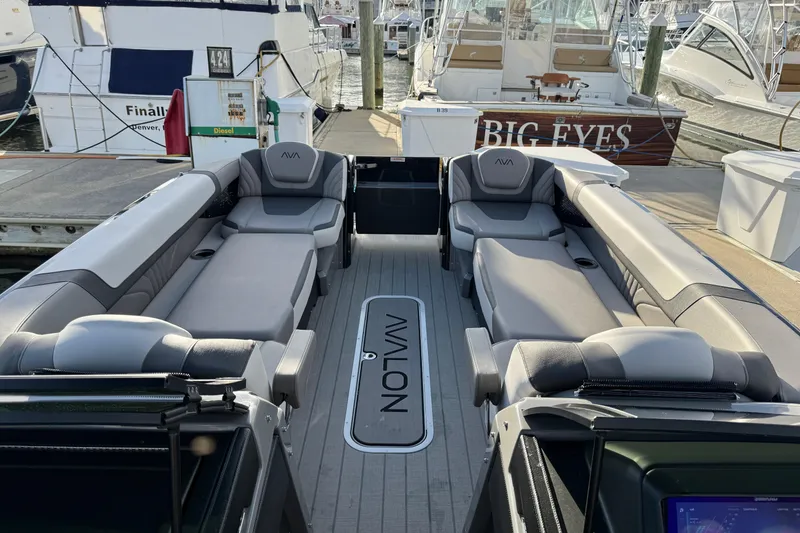 Slide: The Image of 2025 Avalon Excalibur Quad Lounge Windshield boat interior at marina dock. - 35